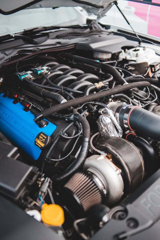 Detailed view of a modern car engine featuring a turbocharger, highlighting automotive engineering.